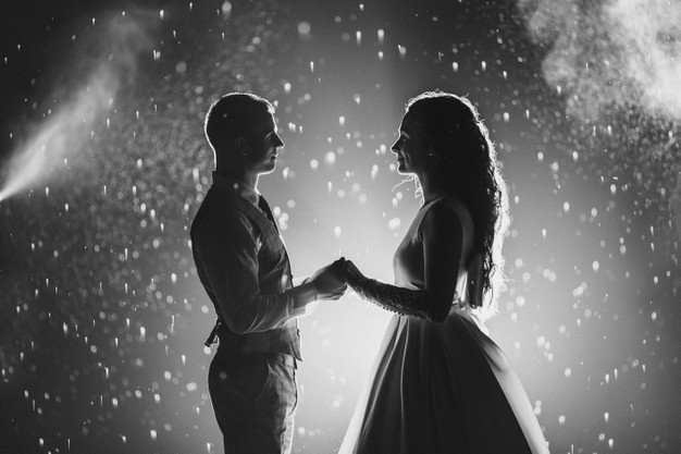 side-view-black-white-stock-photo-cheerful-bride-groom-holding-hands_132075-10438